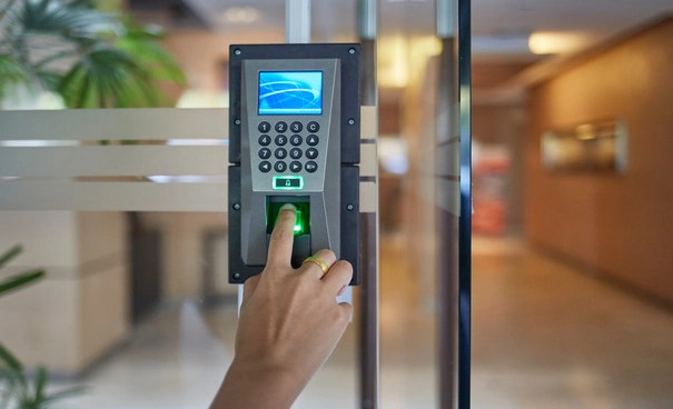A person using a fingerprint scanner for biometric access control.